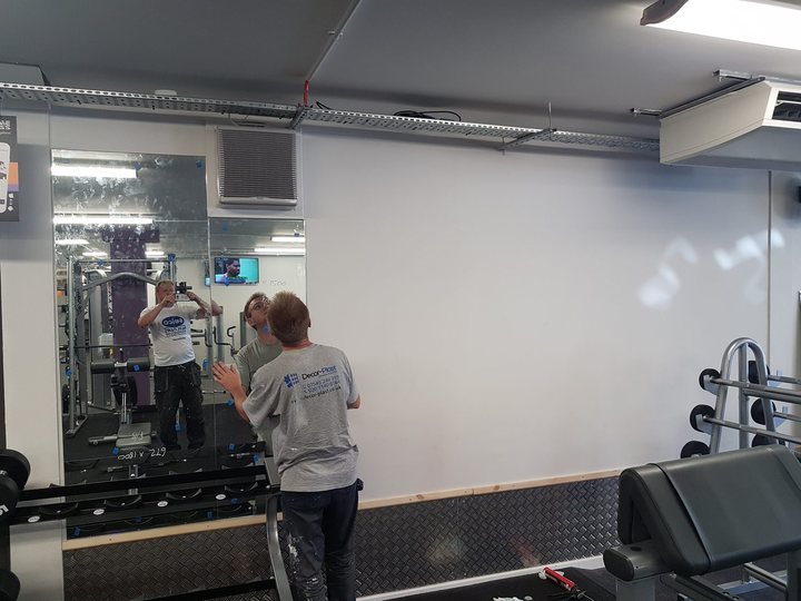 Commercial interior wall being painted in a gym