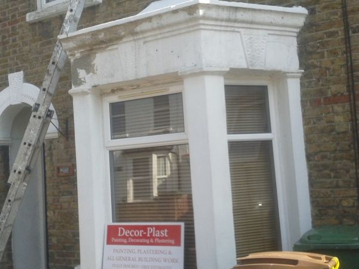 Exterior bay window with freshly painted masonry and trim