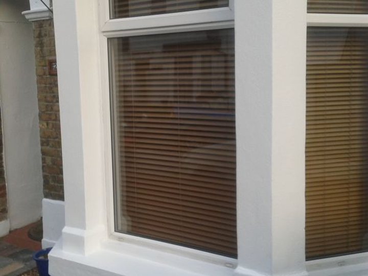 Exterior window and rendered wall with a fresh painted finish