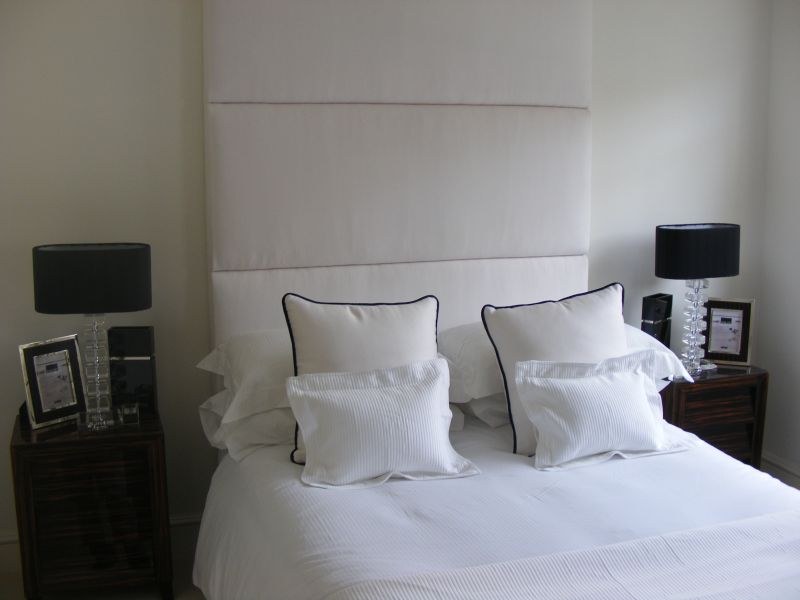 Bedroom with painted wall panelling and white trim