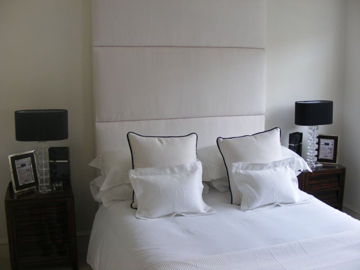 Bedroom with painted wall panelling and white trim