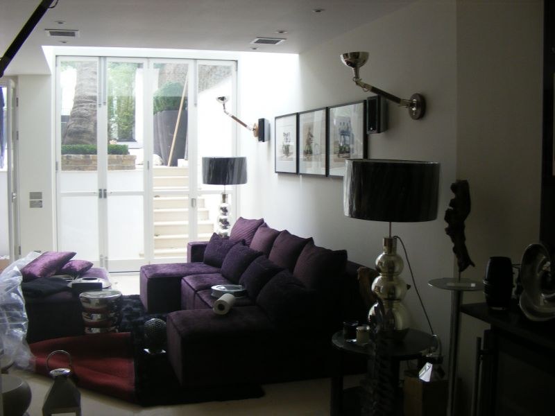 Bright living room with crisp white walls and dark feature furnishings