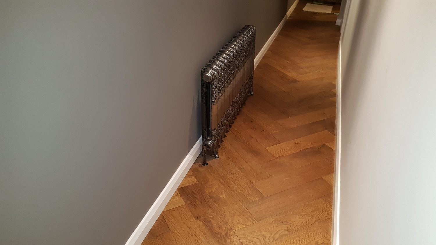 Finished hallway with smooth painted walls and woodwork