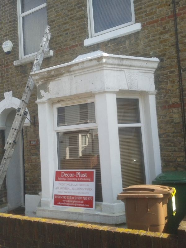 Exterior bay window with freshly painted masonry and trim